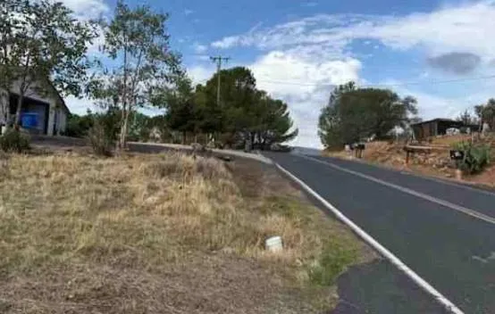 a view of a street with a building in the background