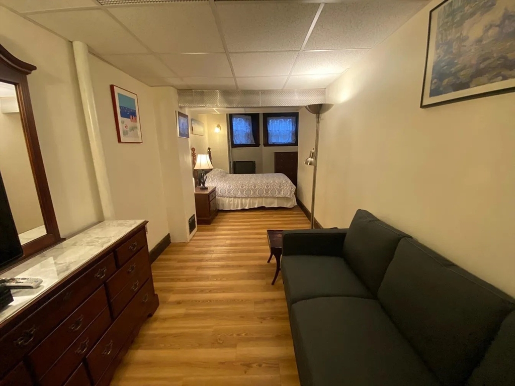 72 Bay State Road, Unit G Boston, MA 02215 - Photo 13 of 25 a living room with furniture and a couch