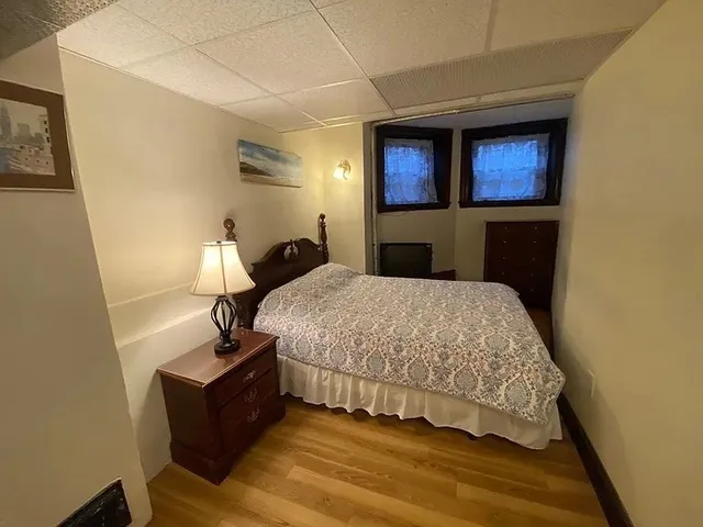 a bedroom with a bed and a night stand