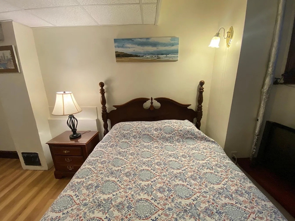 72 Bay State Road, Unit G Boston, MA 02215 - Photo 16 of 25 a bedroom with a bed and wooden floor