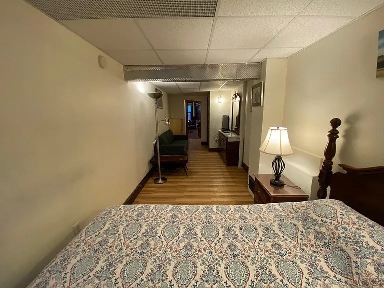 72 Bay State Road, Unit G Boston, MA 02215 - Photo 17 of 25 a bedroom with a bed a mirror and lamp on desk