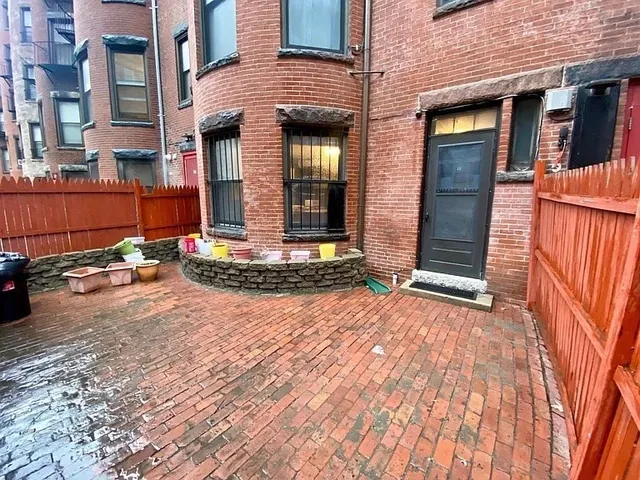 a view of a brick house with many windows