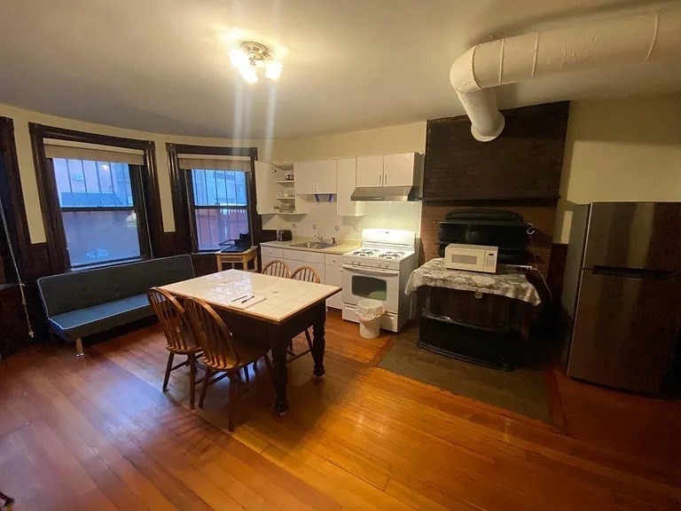 72 Bay State Road, Unit G Boston, MA 02215 - Photo 3 of 25 a living room with furniture wooden floor and a table