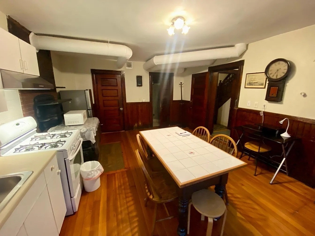 72 Bay State Road, Unit G Boston, MA 02215 - Photo 5 of 25 a view of a dining room with furniture and wooden floor