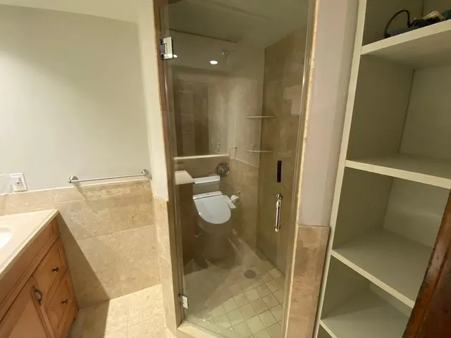 a bathroom with a shower and toilet