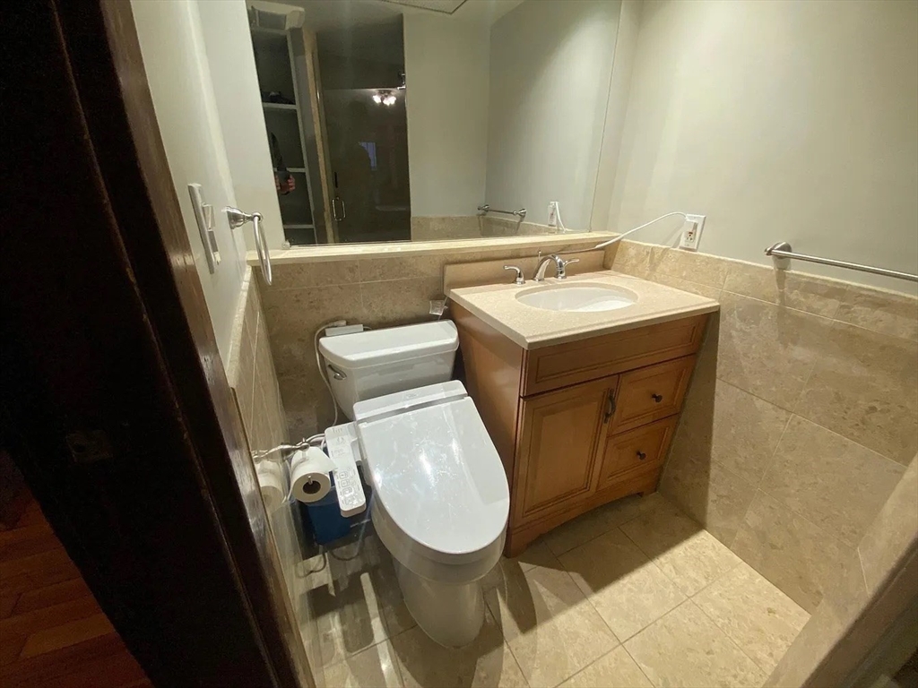 72 Bay State Road, Unit G Boston, MA 02215 - Photo 8 of 25 a bathroom with a toilet a sink and a mirror