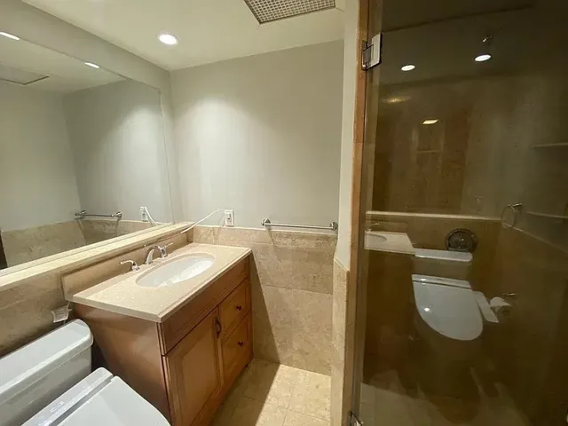 a bathroom with a sink toilet and shower
