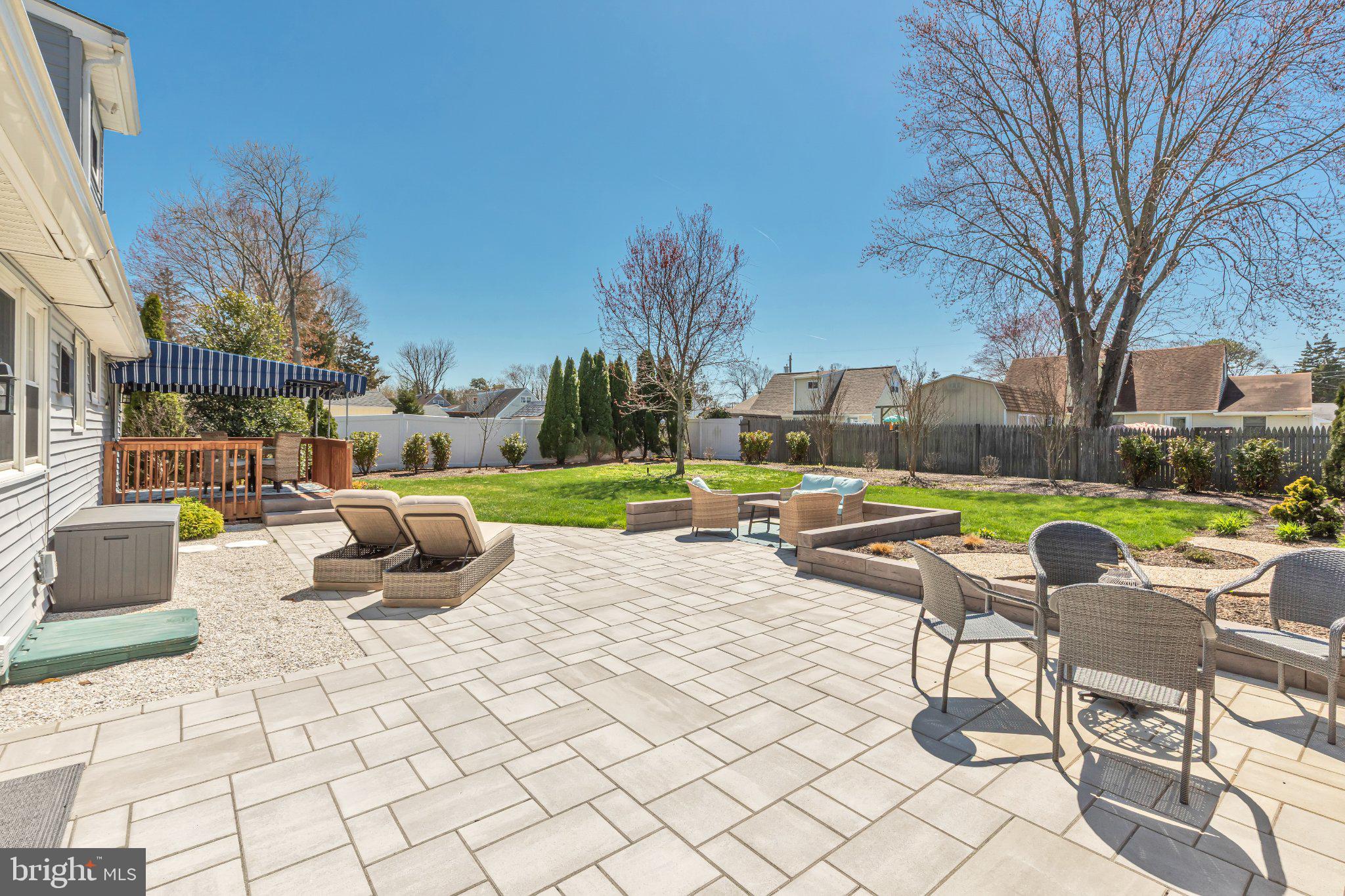 Sunny backyard oasis with patio charm.
