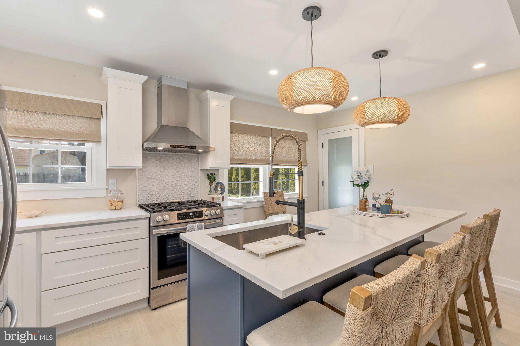 126 Colwick Drive Somers Point, NJ 08244 - Photo 13 of 46 a kitchen with a stove a sink a chandelier and a dining table