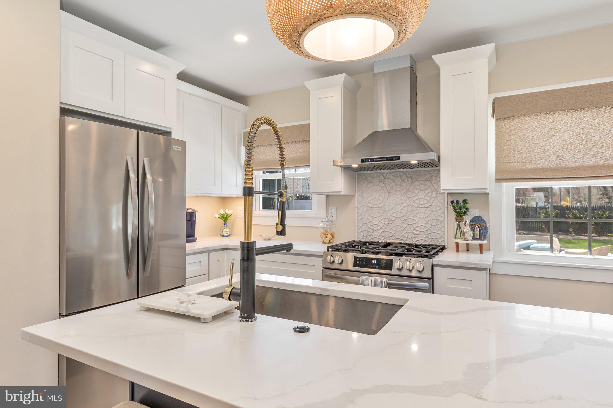 126 Colwick Drive Somers Point, NJ 08244 - Photo 16 of 46 a kitchen with granite countertop a stove a refrigerator and a dining table