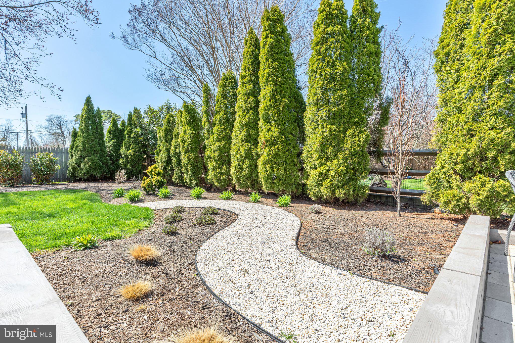 126 Colwick Drive Somers Point, NJ 08244 - Photo 43 of 46 Serene garden path with lush greenery.