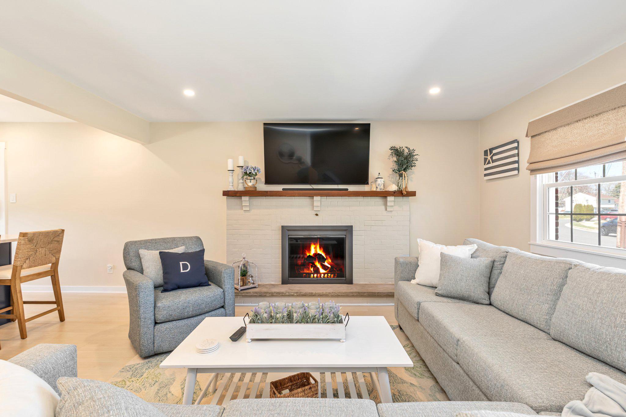 126 Colwick Drive Somers Point, NJ 08244 - Photo 8 of 46 a living room with furniture a flat screen tv and a fireplace