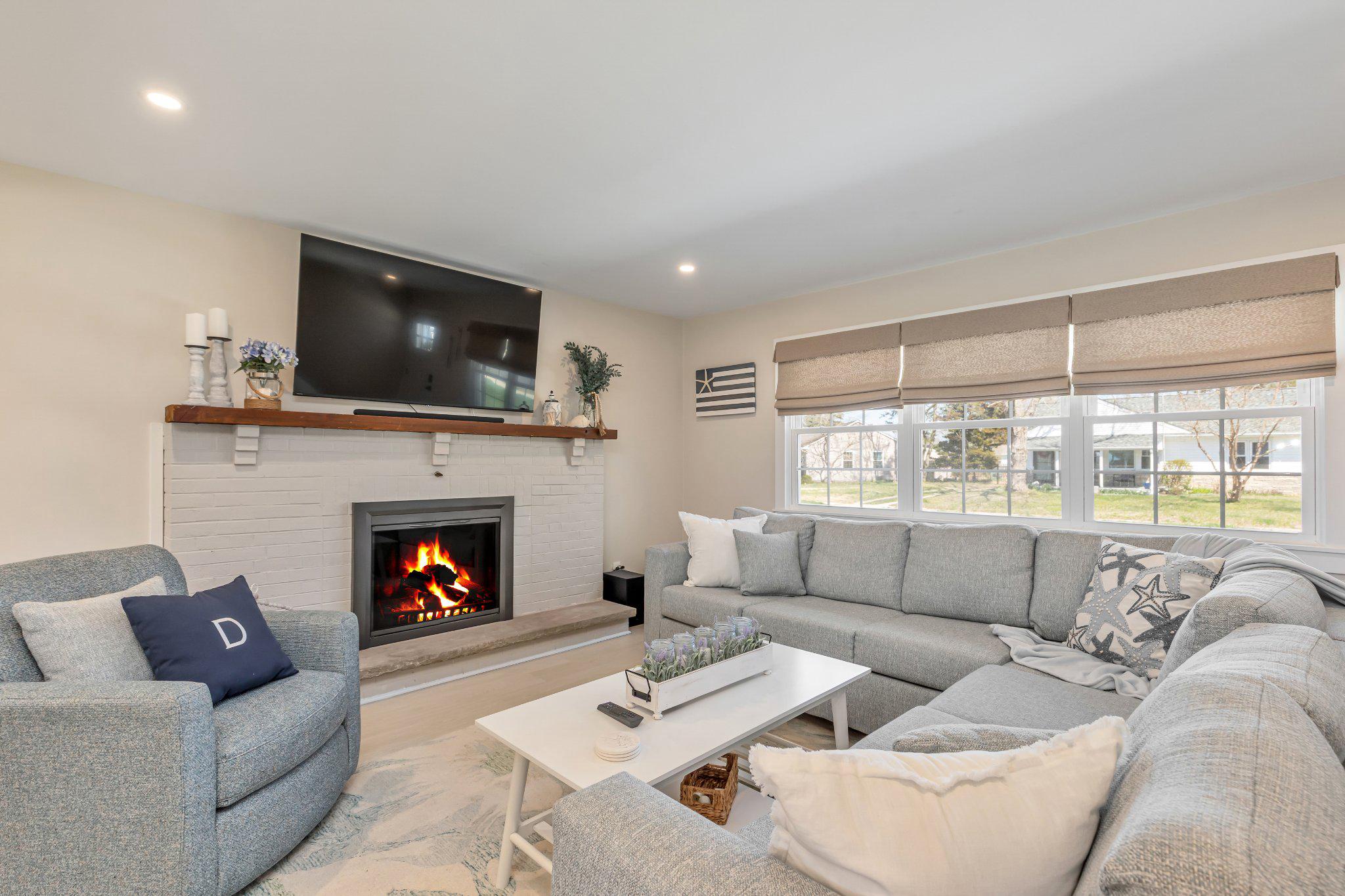 126 Colwick Drive Somers Point, NJ 08244 - Photo 9 of 46 a living room with furniture a fireplace and a flat screen tv