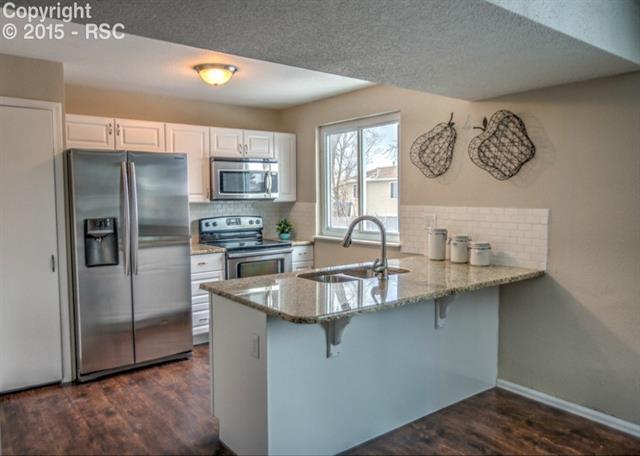1730 Doherty Road Colorado Springs, CO 80916 - Photo 12 of 32 The Kitchen has stainless steel appliances