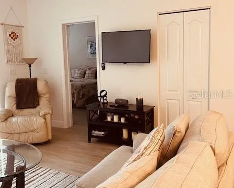 a living room with furniture and a flat screen tv