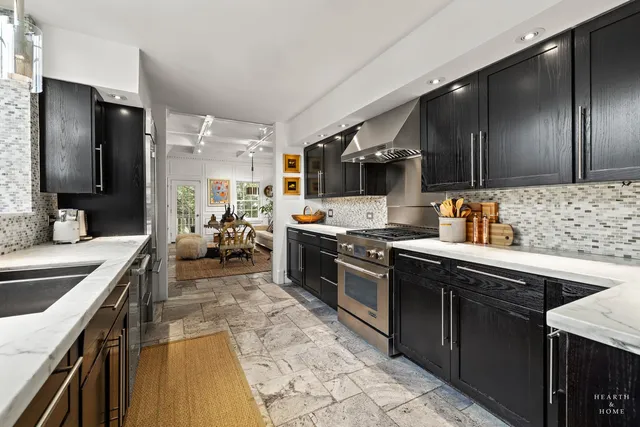 a view of a patio with a table and chairs under an umbrella