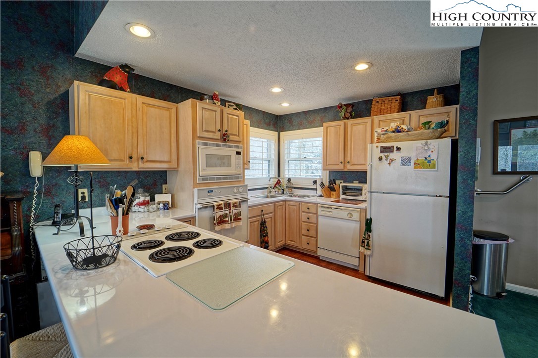 710-708 Pine Ridge Road Beech Mountain, NC 28604 - Photo 17 of 42 a kitchen with a sink a stove and refrigerator