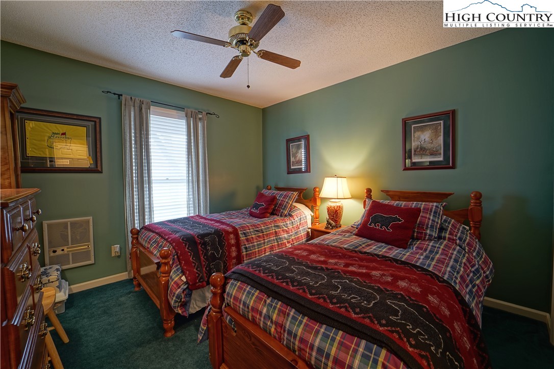 710-708 Pine Ridge Road Beech Mountain, NC 28604 - Photo 24 of 42 a bedroom with two beds and a ceiling fan