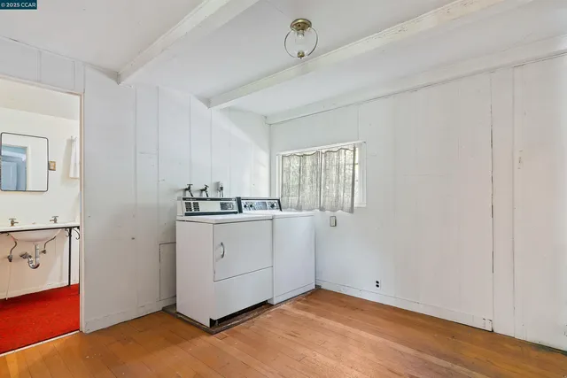 a utility room with cabinets washer and dryer