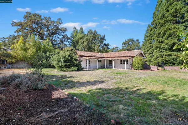 a front view of house with yard and green space