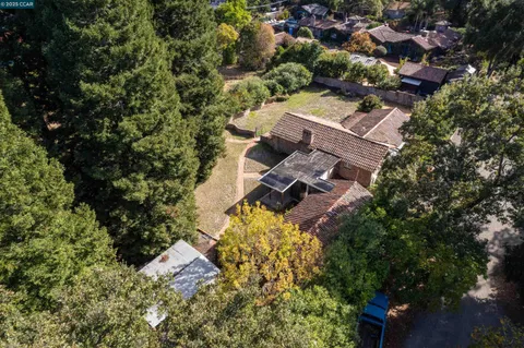 an aerial view of a house with a yard