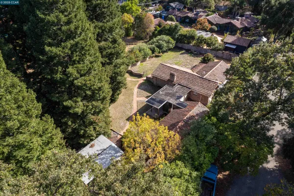 an aerial view of a house with a yard