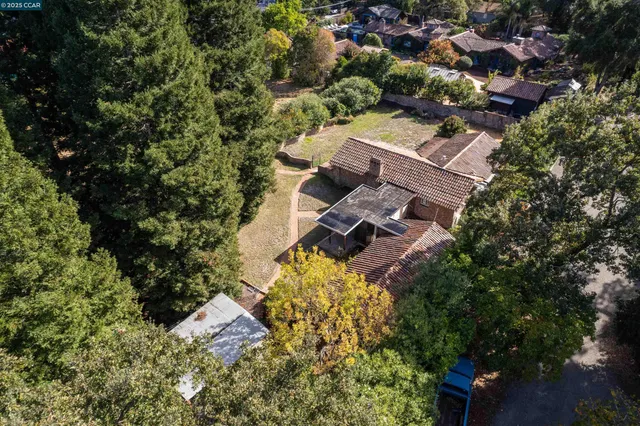 an aerial view of a house with a yard