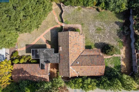 an aerial view of a house with yard and garage