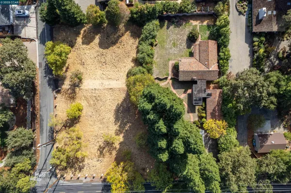 an aerial view of a house with a yard and lake view