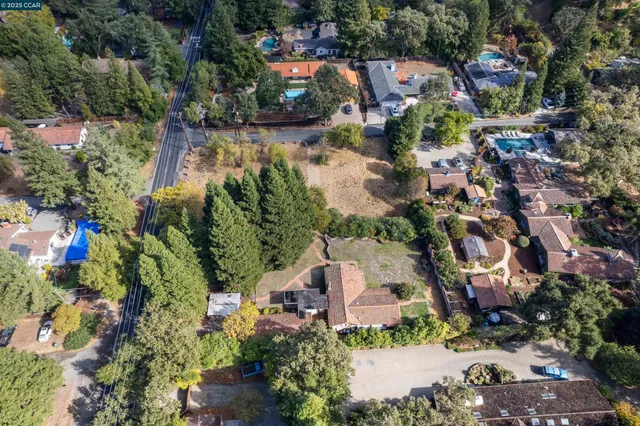 an aerial view of residential houses with outdoor space and swimming pool