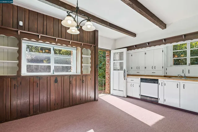 a kitchen with stainless steel appliances granite countertop cabinets and window