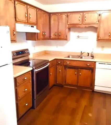 a kitchen with a stove and a refrigerator