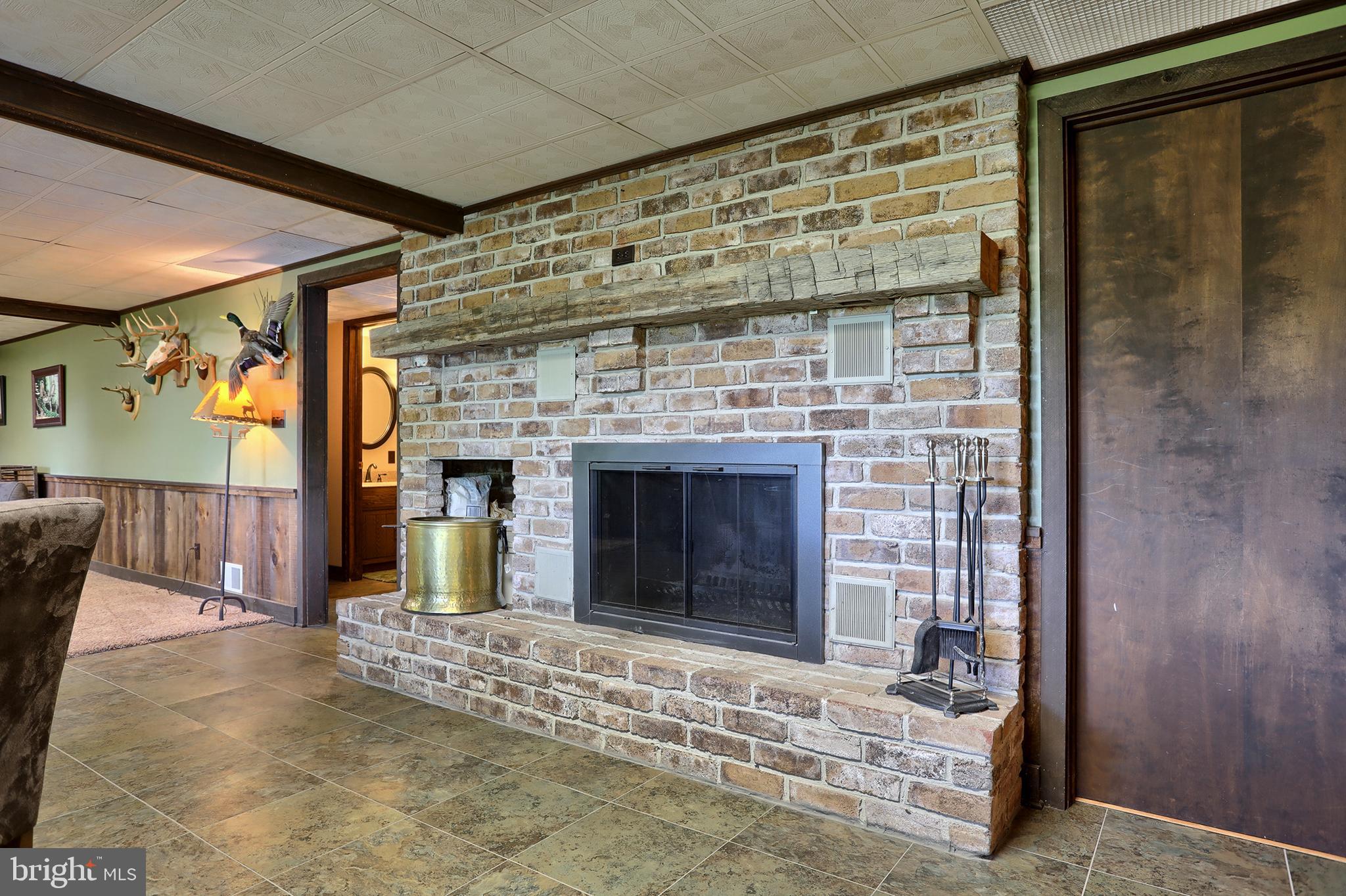 704 Church Road Manheim, PA 17545 - Photo 29 of 46 Wood burning fireplace with brick surround