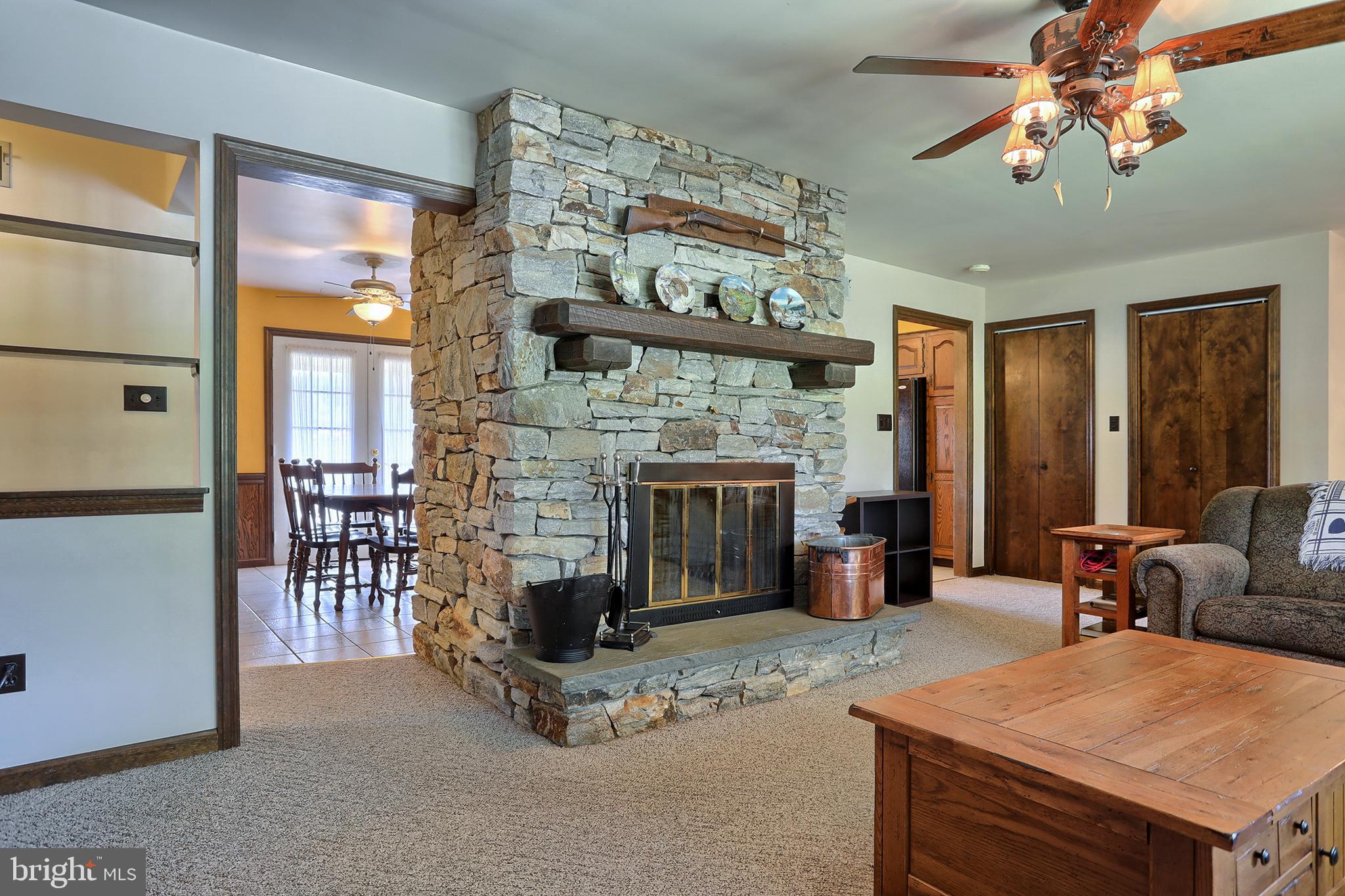 704 Church Road Manheim, PA 17545 - Photo 10 of 46 Living room with wood burning stone fireplace