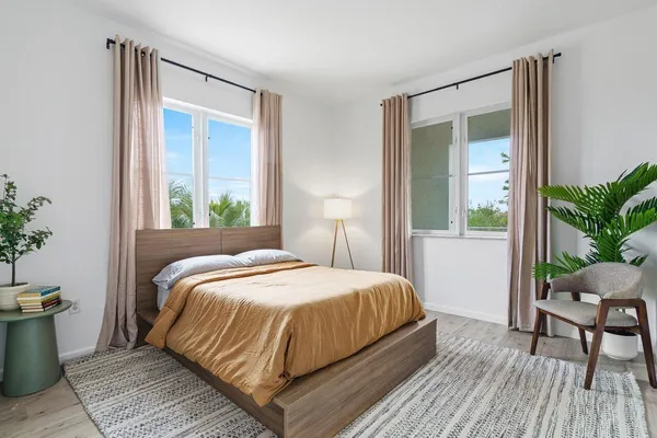 a bedroom with a bed and a potted plant