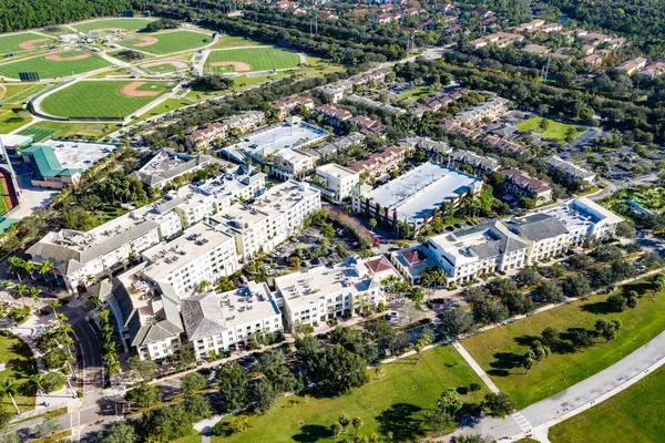 an aerial view of residential houses with outdoor space and street view