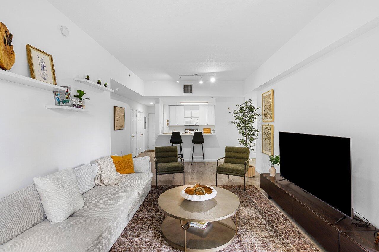 1209 Main Street, Unit 302 Jupiter, FL 33458 - Photo 2 of 20 a living room with furniture and a flat screen tv