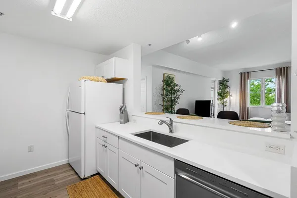 a kitchen with a sink and a refrigerator