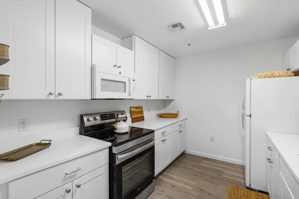 a kitchen with cabinets and appliances