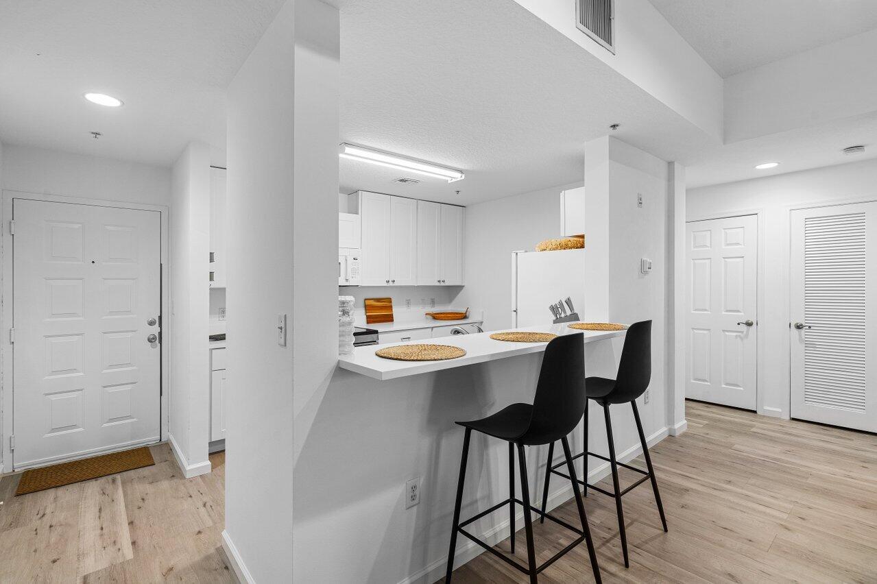 1209 Main Street, Unit 302 Jupiter, FL 33458 - Photo 10 of 20 a view of a dining room with furniture and wooden floor