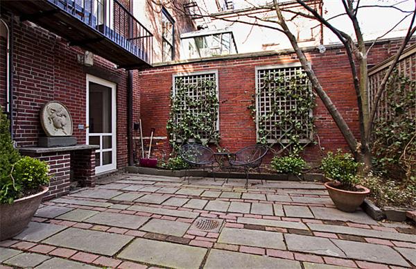 74 Chestnut Street Boston, MA 02108 - Photo 13 of 13 a brick building with a bench and potted plants