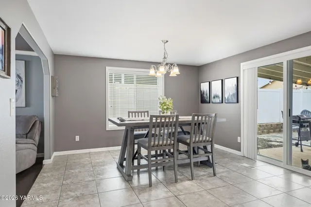 a view of a dining room with furniture and chandelier