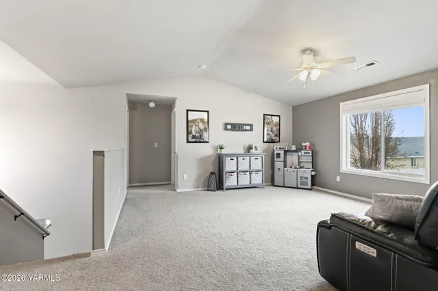 a living room with furniture and white walls