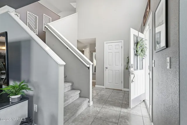 a view of entryway and hall with wooden floor