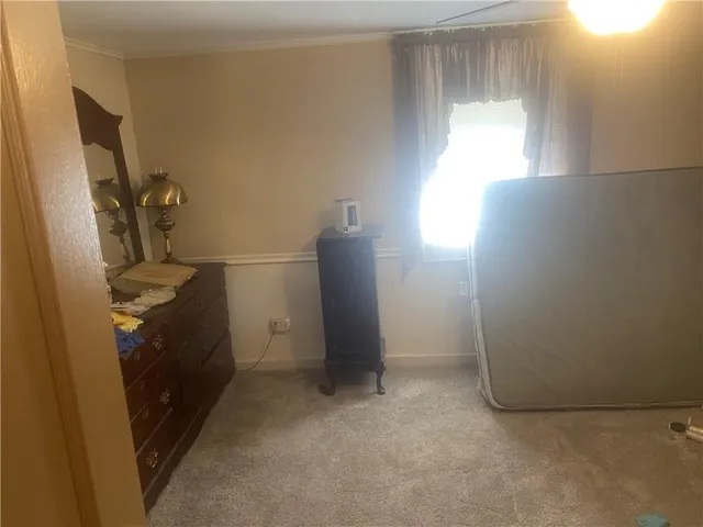 a room with a mirror and a dresser