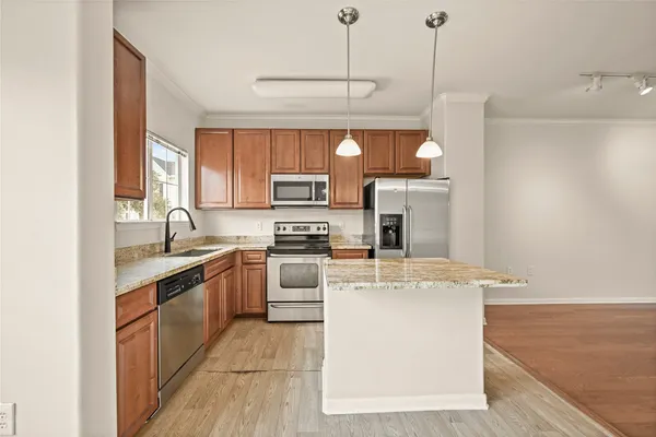 a kitchen with cabinets a sink and appliances