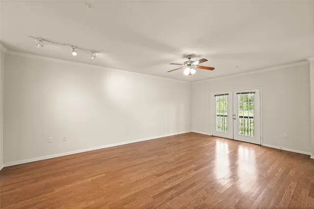a view of an empty room with wooden floor