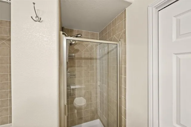 a bedroom with a bed and a chandelier fan