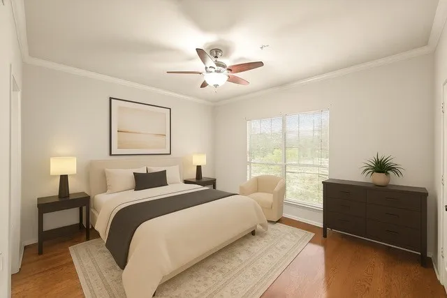 an empty room with wooden floor and ceiling fan