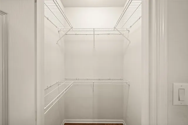 a bathroom with a granite countertop sink toilet a mirror and shower